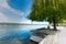 Tourist enjoys a break under a willow on the shores on Lake Constance in Steckborn