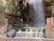 A tourist enjoys the hot spring waterfall and natural pool at Hammamat Ma`In Hot Springs, Jordan