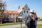 Tourist enjoys view of Capuchin monastery in Olesko, Lviv region, western Ukraine by Olesko Castle. Traveling in spring