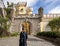 Tourist, entrance arch of The Pena Palace, a Romanticist Castle in Sao Pedro de Penaferim, in Sintra, on the Portuguese Riviera.
