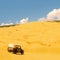 Tourist escapade Yellow sand dunes with a Jeep car