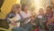 Tourist family singing song by guitar in camping tent in forest hike. Friendly family singing song at camping on