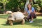 Tourist feeding giant turtle