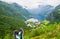 Tourist feet on the Geiranger village and Geirangerfjord landscape background. Norway