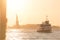 Tourist Ferry and Statue of Liberty in Sunlit New York Harbor