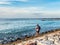 Tourist fishing off the rocks in Kuta Bali