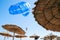 A tourist flies a blue parachute in the sky