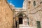 A tourist in front of The 9th station of the cross in Via Dolorosa at the entree to the Coptic Orthodox Patriarchate, St. Anthony