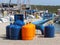 Tourist gas cylinders Stand on the pier in the marina against the backdrop of sailing yachts. Preparations for a charter cruise. C