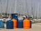 Tourist gas cylinders Stand on the pier in the marina against the backdrop of sailing yachts. Preparations for a charter cruise. C