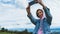 Tourist girl on background blue sky clouds taking photo selfie on mobile smart phone, person looking on camera gadget technology