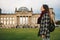 A tourist girl with a backpack next to the building called the Reichstag in Berlin in Germany. Sightseeing, tourism