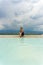 Tourist girl in dress with hat in Natural travertine pools and terraces in Pamukkale. Cotton castle in Turkey. Woman in pamukkale.