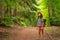 Tourist girl enjoying hiking with backpack in national park. Happy child walking in the forest in summer. Active