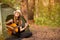 Tourist girl in hat sits in tent and playing guitar concept. Tourism rest on nature.