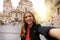 Tourist girl in Murcia taking selfie photo with the Cathedral Church of Saint Mary and cityscape on the background. Girl takes