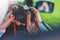 Tourist girl in an open window of a auto car taking photography click on retro vintage photo camera crop, photographer looking