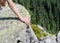 Tourist girl`s hand. Hike. Mountains and rocks.