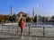 Tourist girl shoots a fountain on a smartphone in Sultanahmet Square in front of Hagia Sophia in Istanbul Turkey. Young adult