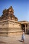 Tourist girl shoots a photograph of an ancient temple. Krishna Temple, Hampi, Karnataka state, India