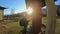 Tourist girl spins a prayer wheel next to a Buddhist temple at sunny day