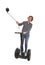 Tourist girl taking selfie photo with mobile phone while riding on segway