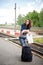 Tourist girl waiting at the railway track