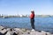 Tourist girl wear hat red sweater at Daiba beach famous landmark at Japan