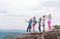 Tourist Group With Backpack Take Photo Of Landscape From Mountain Top On Cell Smart Phone