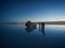 Tourist group with offroad car SUV on Salar de Uyuni salt flat lake in Bolivia andes mountains sunrise mirror reflection