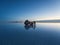 Tourist group with offroad car SUV on Salar de Uyuni salt flat lake in Bolivia andes mountains sunrise mirror reflection