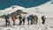 Tourist group walking on snow trail in mountain. Winter mountain landscape
