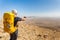 Tourist guide backpacker pointing showing directions desert mountains, Israel.