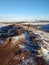 A tourist guy walks near Kerid lake in winter in Iceland. Incredible winter landscape of Iceland