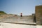Tourist happy in Festos ruins Crete