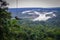 Tourist having fun in the air held by a rope. Fabulous Amazonian landscape