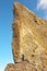 Tourist on the heel of a high rock of rocky port La Breche de Roland, border between France and Spain, Pyrenees