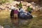 Tourist helps wash an elephant