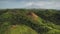 Tourist hike mountain top aerial view. Philippine landmark for travelers. Burnt grass on green mount