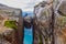 The tourist hiker man take a selfie while sitting on top of Kjeragbolten - the most dangerous stone in the world. Norway