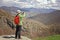 Tourist hiker taking photo using smart phone in Armenian mountains.