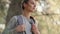 Tourist hiker young girl with backpack walking in fall woods