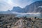 Tourist hikers enjoy the view at Upper Grinnell Lake in Glacier National Park