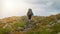 Tourist with hiking backpack walk along a mountain trail. Background illustrating a healthy lifestyle