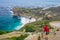 Tourist hiking at Cape Point, looking at view of Cape of Good Hope and Dias Beach, scenic travel destination in South Africa. Tabl