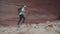 Tourist Hiking In A Desert Slot Canyon With Orange Monolithic Rocks Formation