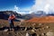 Tourist hiking in Haleakala volcano crater on the Sliding Sands trail. Beautiful view of the crater floor and the cinder cones bel