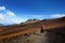 Tourist hiking in Haleakala volcano crater on the Sliding Sands trail. Beautiful view of the crater floor and the cinder cones bel