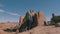 Tourist Hiking On Orange Sandstone Rock Cliffs In Desert At Sunset