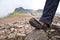 Tourist in hiking shoes atop the mountain